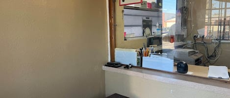 A room with a window, a desk, and a chair.