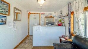A compact living space with a kitchenette, a dining area, and a seating area.