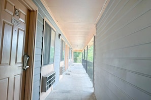 A corridor with a door labeled '216' and a window on the left.
