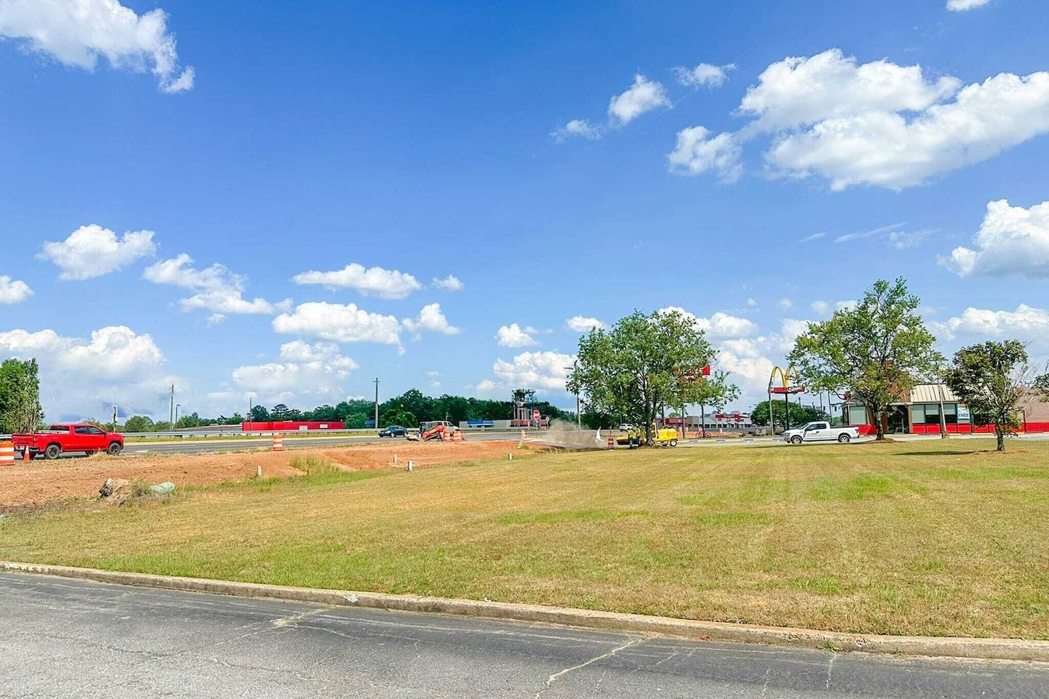 A parking lot with a McDonald's restaurant in the background.