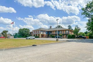 A two-story building with a flat roof and a flagpole with an American flag.