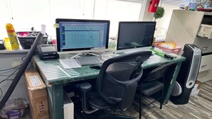 A workspace with two monitors, a keyboard, a mouse, a chair, a desk, and a computer tower. - 2 Full Beds|Non-Smoking (Merritt Island FL)