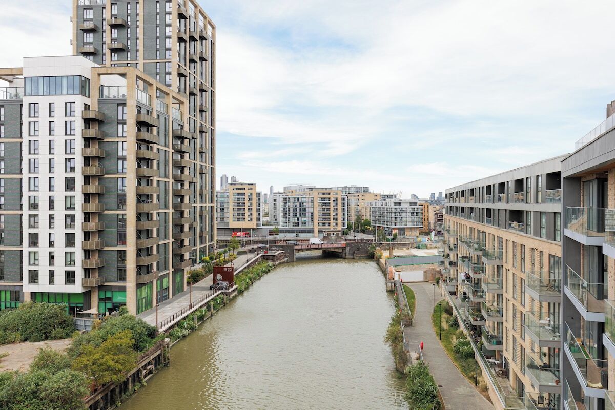 A river running through a modern urban area with high-rise buildings on either side.
