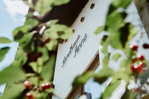 A sign with the text 'Landhaus Anna' partially obscured by foliage. - Landhaus Anna Allgäu, Bavaria (Rettenberg)
