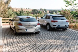 Two cars parked on a paved area with a view of a hilly landscape in the background. - Holiday home with 1 bedroom (Harzgerode OT Güntersberge)