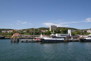 A harbor with boats, a bridge, and buildings in the background. - Holiday home in Dranske with swimming pool (Dranske)
