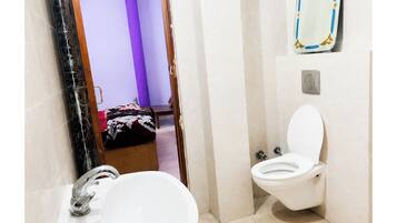 Shower, rainfall showerhead, slippers, towels