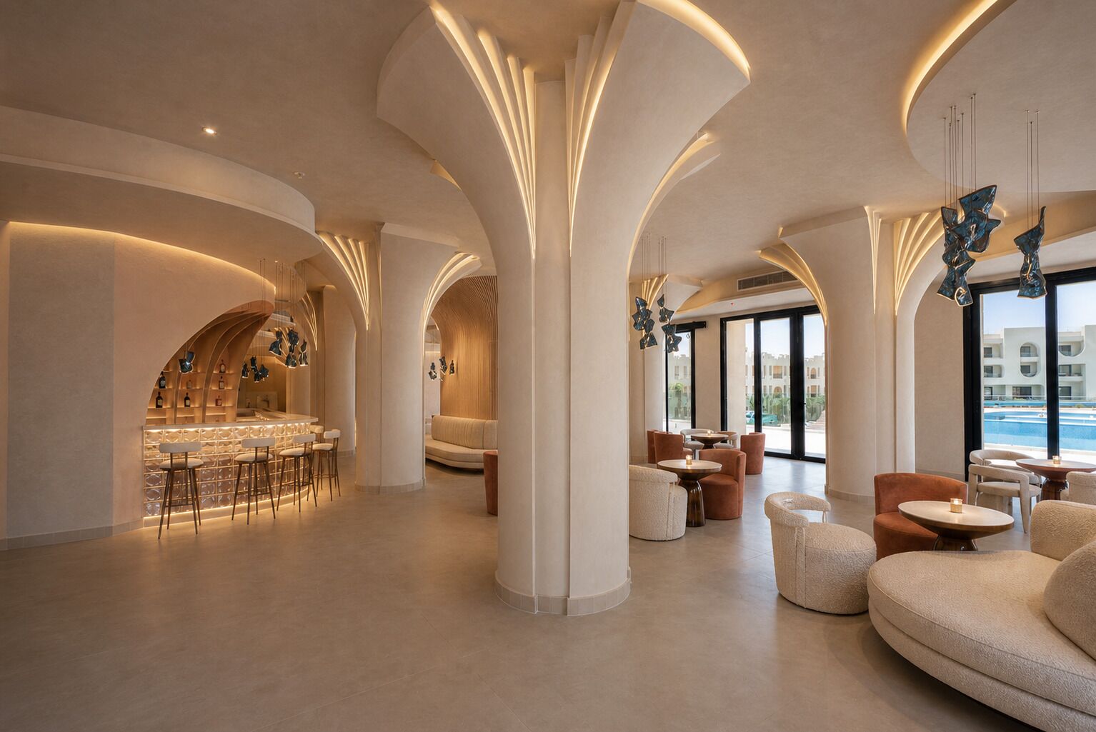 A modern interior with a bar area, seating, and large windows.