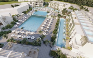 Ein Resort mit mehreren Schwimmbecken, Liegestühlen und Palmen.