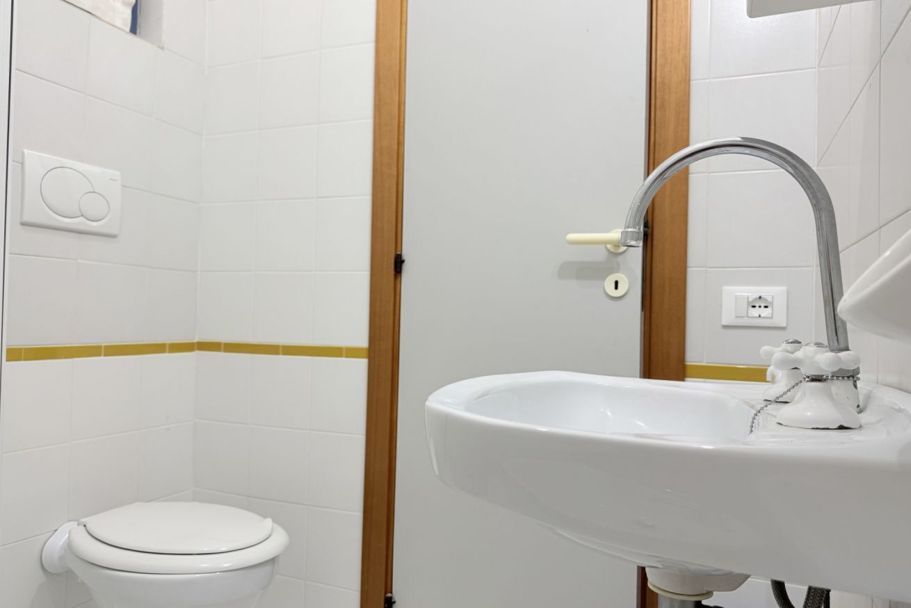 Une salle de bain avec des toilettes, un lavabo et un miroir.