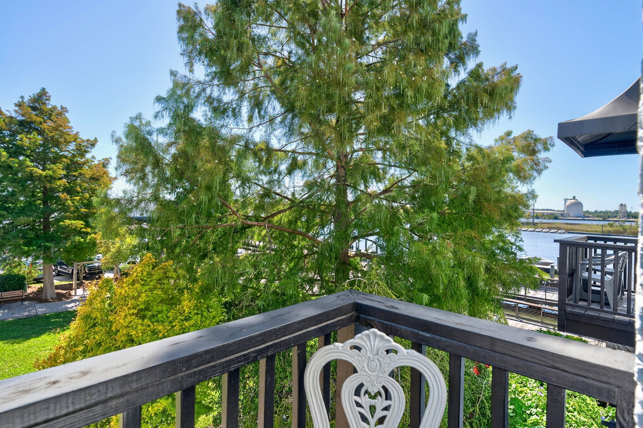 A balcony with a railing, overlooking a body of water and a dock.