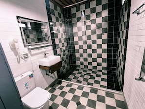 A bathroom with a checkered floor, a sink, a toilet, and a shower area. - Fortuna Boutique Hotel & Restaurant (Gabala)