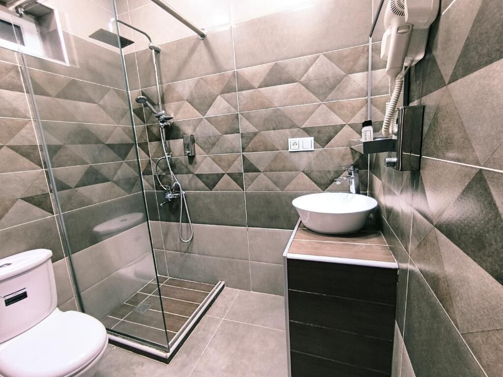 Habitación cuádruple Confort, vistas al patio | Baño | Ducha y cabezal de ducha tipo lluvia