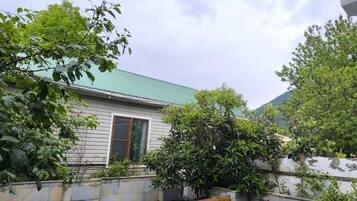 Comfort Quadruple Room, Courtyard View | Living area | 43-inch LED TV with satellite channels