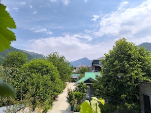 A pathway leading through a lush green area with buildings in the background. - Fortuna Boutique Hotel & Restaurant (Gabala)