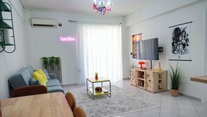 A living room with a sofa, a coffee table, a TV, and a chandelier. - In the heart of Nafpaktos's city center, 50m from the sea and 5' from the port. (Nafpaktos)