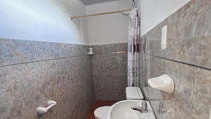 A bathroom with a toilet, sink, and shower area. - "Sleeping Woman" Accommodation (Ambuquí)