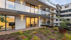 Un immeuble moderne à plusieurs étages, doté de balcons et de grandes fenêtres.