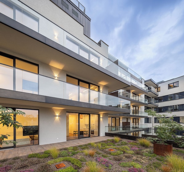 A modern multi-story building with balconies and large windows.