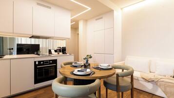 Une cuisine moderne avec un coin repas, des meubles blancs et une table à manger en bois avec des chaises.