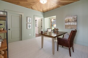 A dining area with a wooden table and chairs, a light-colored carpet, and a ceiling with wooden beams. - Above Nashville Tranquility | Pool & Spa | 10 Acres | Gated (Nolensville)