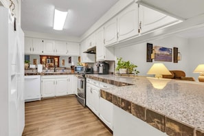 A modern kitchen with white cabinetry, granite countertops, and stainless steel appliances. - The Garden View / Near DFW Airport & AT&T stadium (Euless)