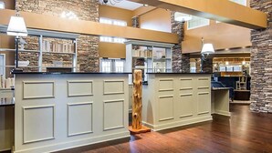 A spacious kitchen with a central island, stone accents, and built-in shelving.
