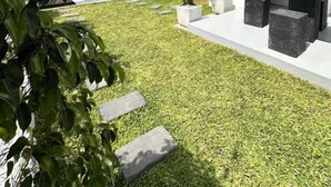 A modern house with a well-maintained lawn, outdoor seating, and a staircase leading to an upper level. - La Costa Hotel (Seeduwa)