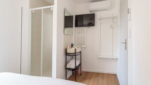 A bathroom with a shower, a sink, a mirror, a television, and a towel rack. - Town house + Parking and garden 5 min Bretonneau Tours center (Tours)
