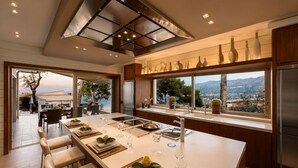 Una cocina moderna con una isla grande, electrodomésticos de acero inoxidable y vistas a la montaña.