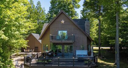 Luxury Bellaire golf resort retreat! Sleeps 12 with 4 king beds, large deck and hot tub on<br>6th green of Hawk’s Eye GC, fire pit, indoor fireplace, and many upscale finishes.<br>Includes private beach club and clubhouse pool access.