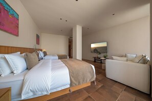 A bedroom with a bed, a sofa, a TV, and a painting on the wall. - Shiliu Fang Homestay (Chongqing)