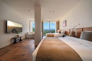 A modern hotel room with a large bed, a flat-screen TV, a large window with a city view, and a wooden headboard. - Shiliu Fang Homestay (Chongqing)