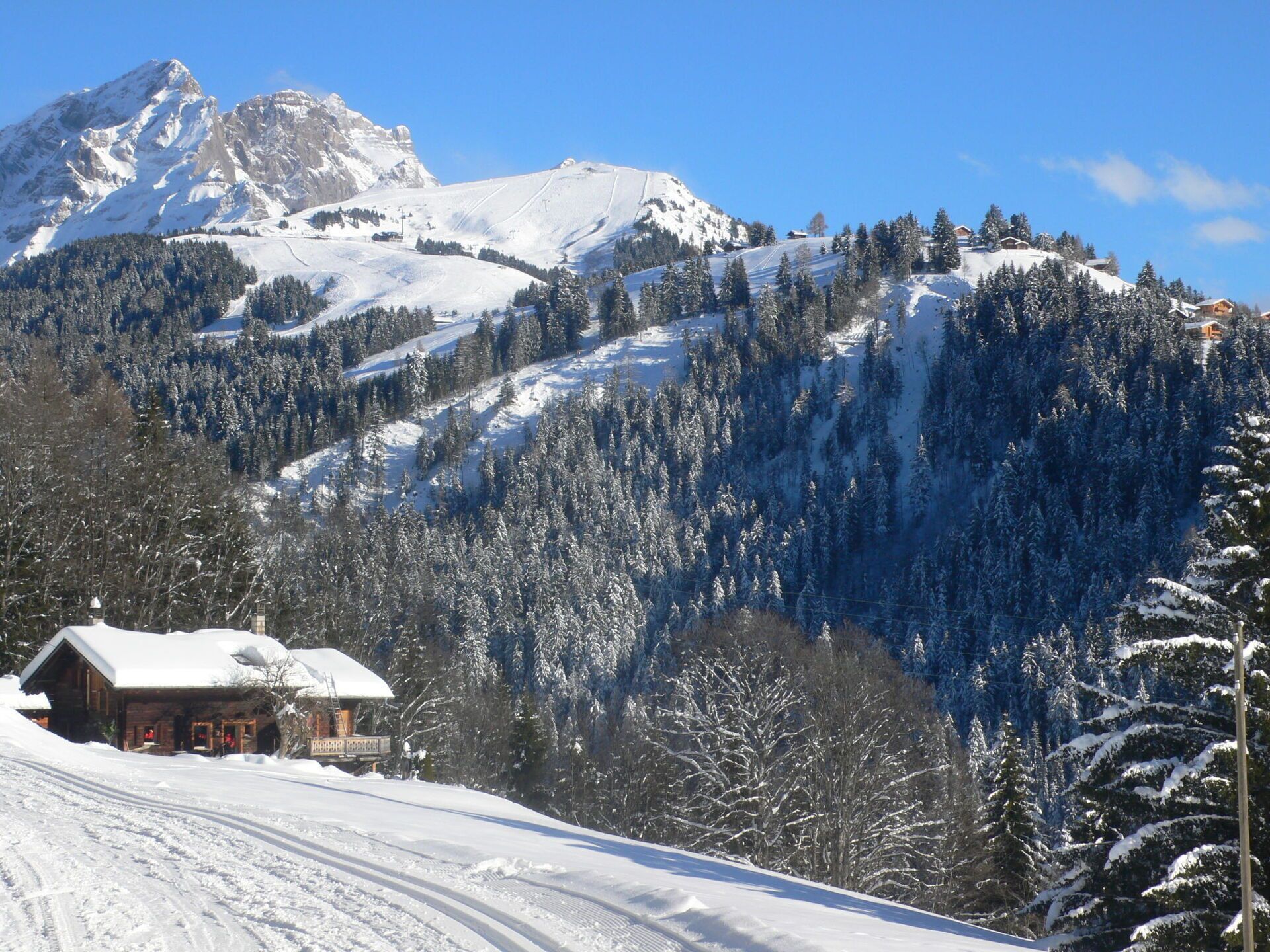A snow-covered mountain landscape with a lodge at the base.