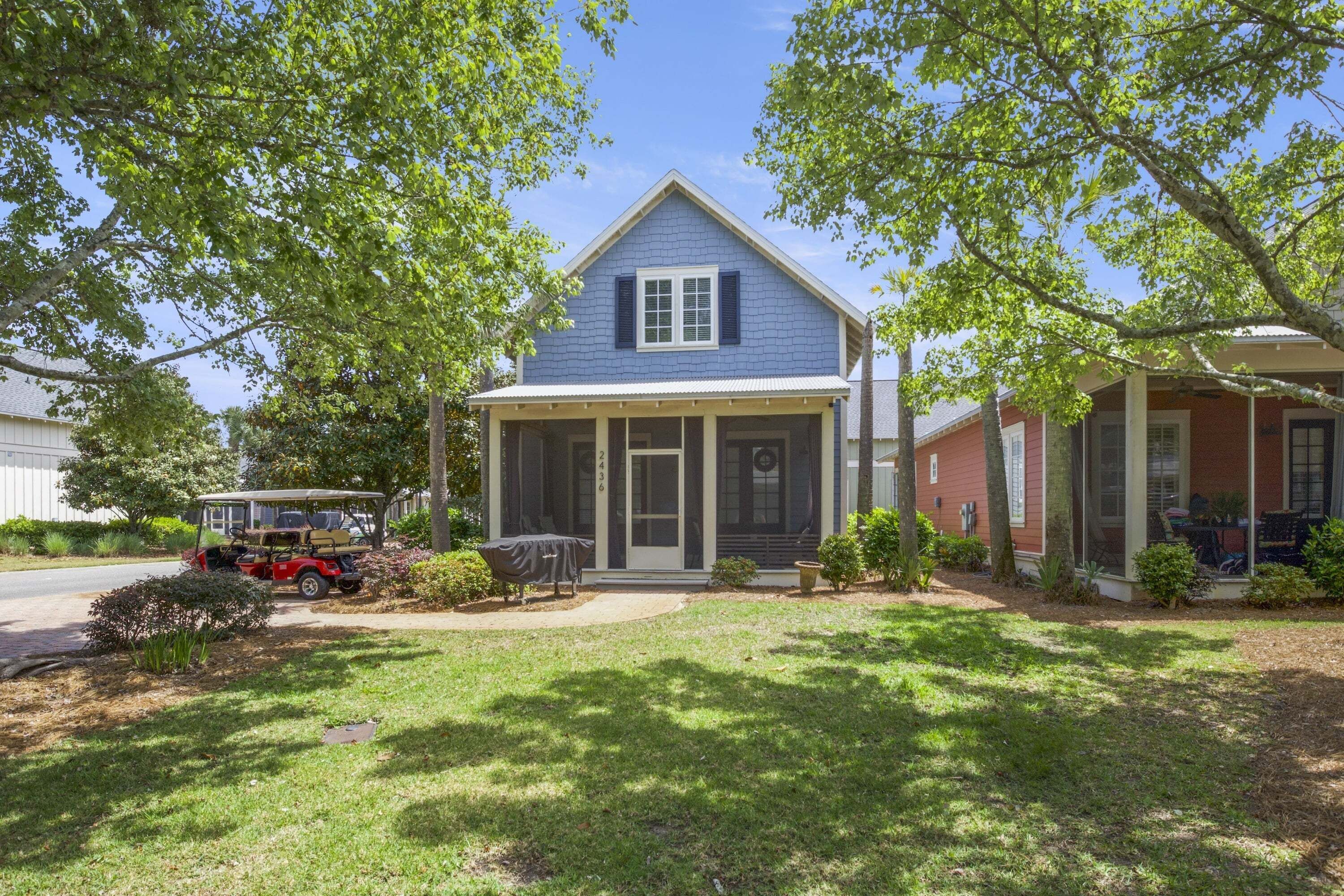 A two-story house with a porch, a garage, and a lawn.