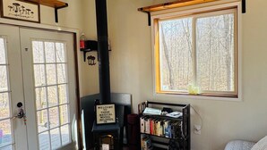 A cozy room with a fireplace, a bookshelf, and a bed.