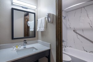 Separate tub and shower, towels, toilet paper