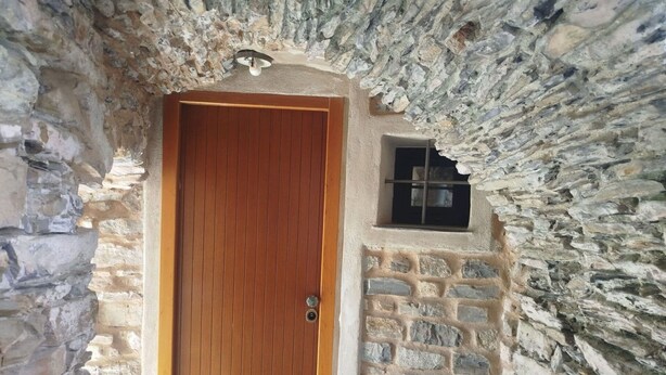 A stone-walled building with a wooden door and a small window. - Beautiful private villa for 2 people with WIFI and terrace (Cipressa)