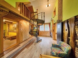A spiral staircase, wooden walls, a colorful chair, and a stone wall. - Beautiful  villa for 6 people with WIFI and TV (Jilemnice)