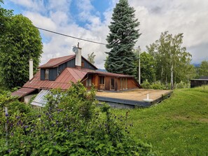 A house with a sloped roof, a chimney, and a small wooden structure. - Stunning  villa for 6 people with WIFI and TV (Jilemnice)