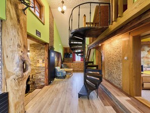 A spiral staircase in a wooden interior with a stone wall and a bench. - Stunning  villa for 6 people with WIFI and TV (Jilemnice)
