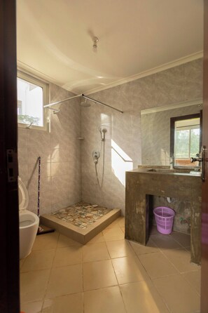 A bathroom with a shower, toilet, and sink. - Serenity Shores (Dar es Salaam)