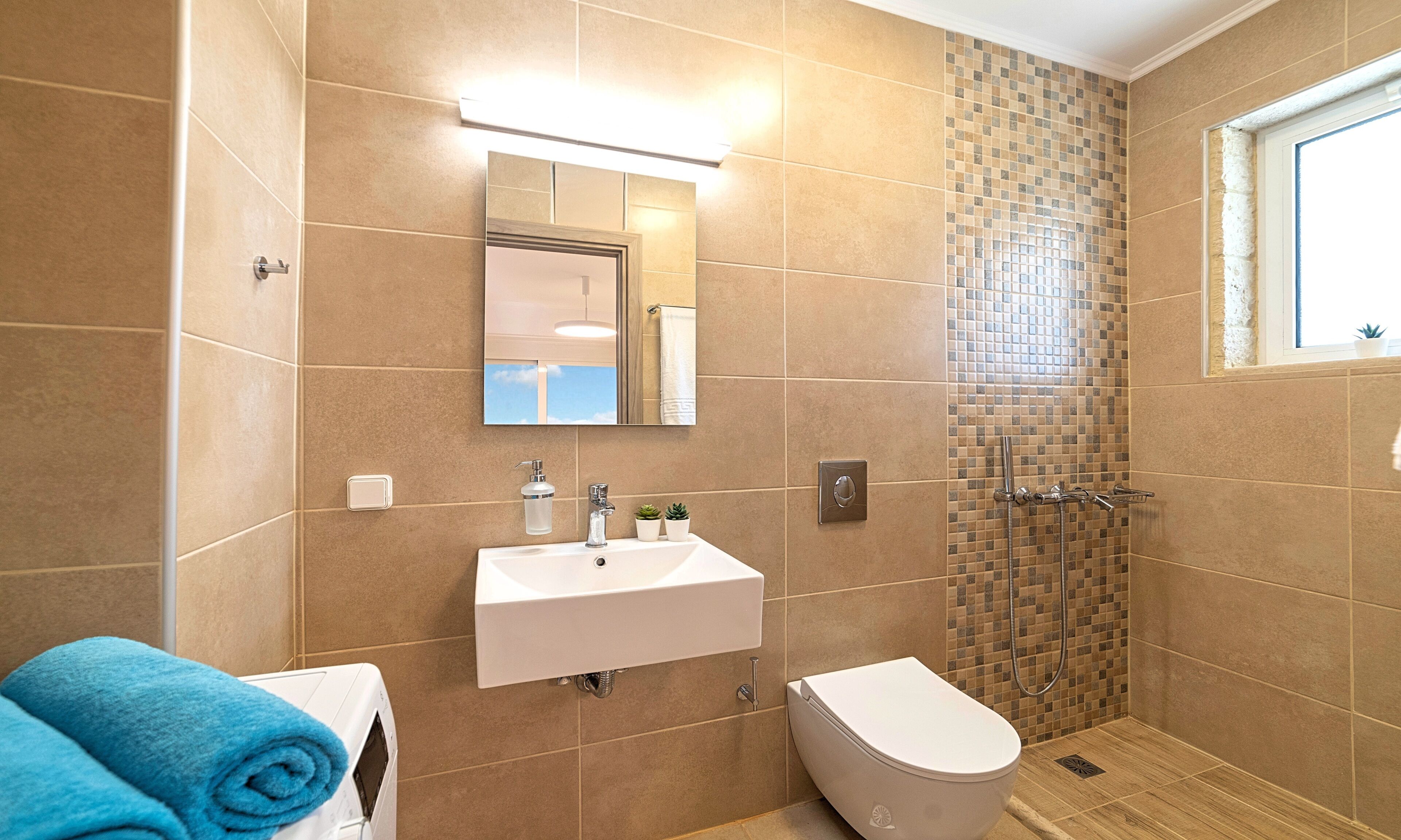 A bathroom with a sink, toilet, and shower.
