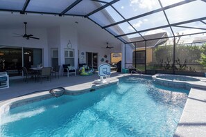 A covered swimming pool with a basketball hoop, seating area, and ceiling fans. - Pelicans Landing - Three Bedroom House, Sleeps 6 (Davenport)