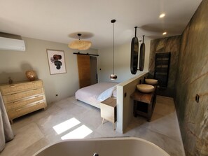 A modern bathroom with a freestanding bathtub, a vanity with a basin, a large mirror, and a ceiling light fixture. - L'Écrin de Nature - Panoramic view & Prestige (Saint-Marcel-lès-Annonay)