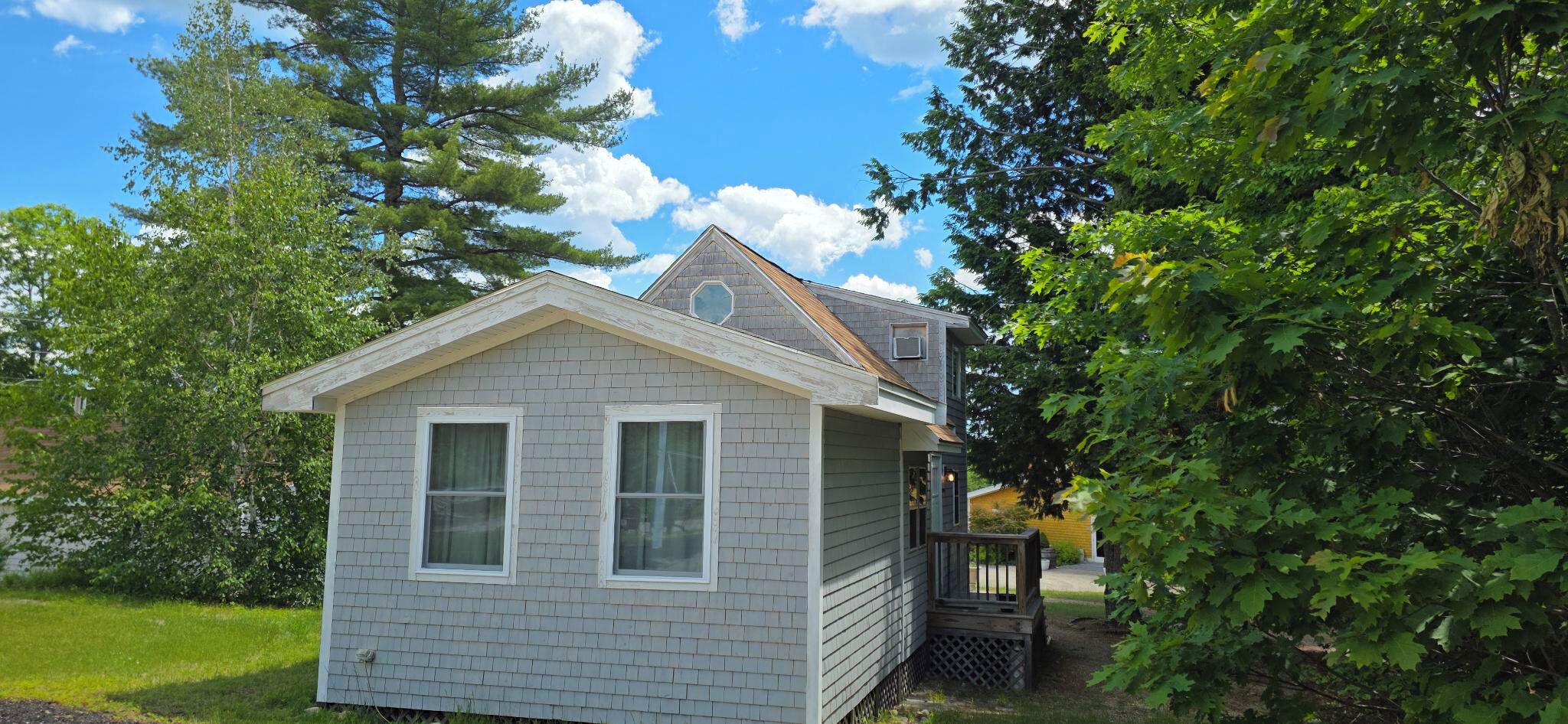 A small, single-story house with a gabled roof and a covered porch.