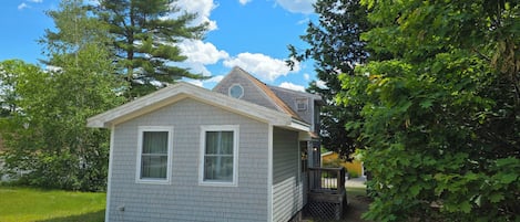 A small, single-story house with a gabled roof and a covered porch.