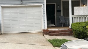 A residential house with a garage, a porch with a chair, and a small garden. - Spacious 3BR Downtown Atlanta Home w/ Parking Minutes to Mercedes-Benz Stadium (Atlanta)