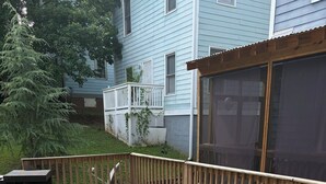 A deck with a patterned floor, a wooden railing, and a house in the background. - Spacious 3BR Downtown Atlanta Home w/ Parking Minutes to Mercedes-Benz Stadium (Atlanta)