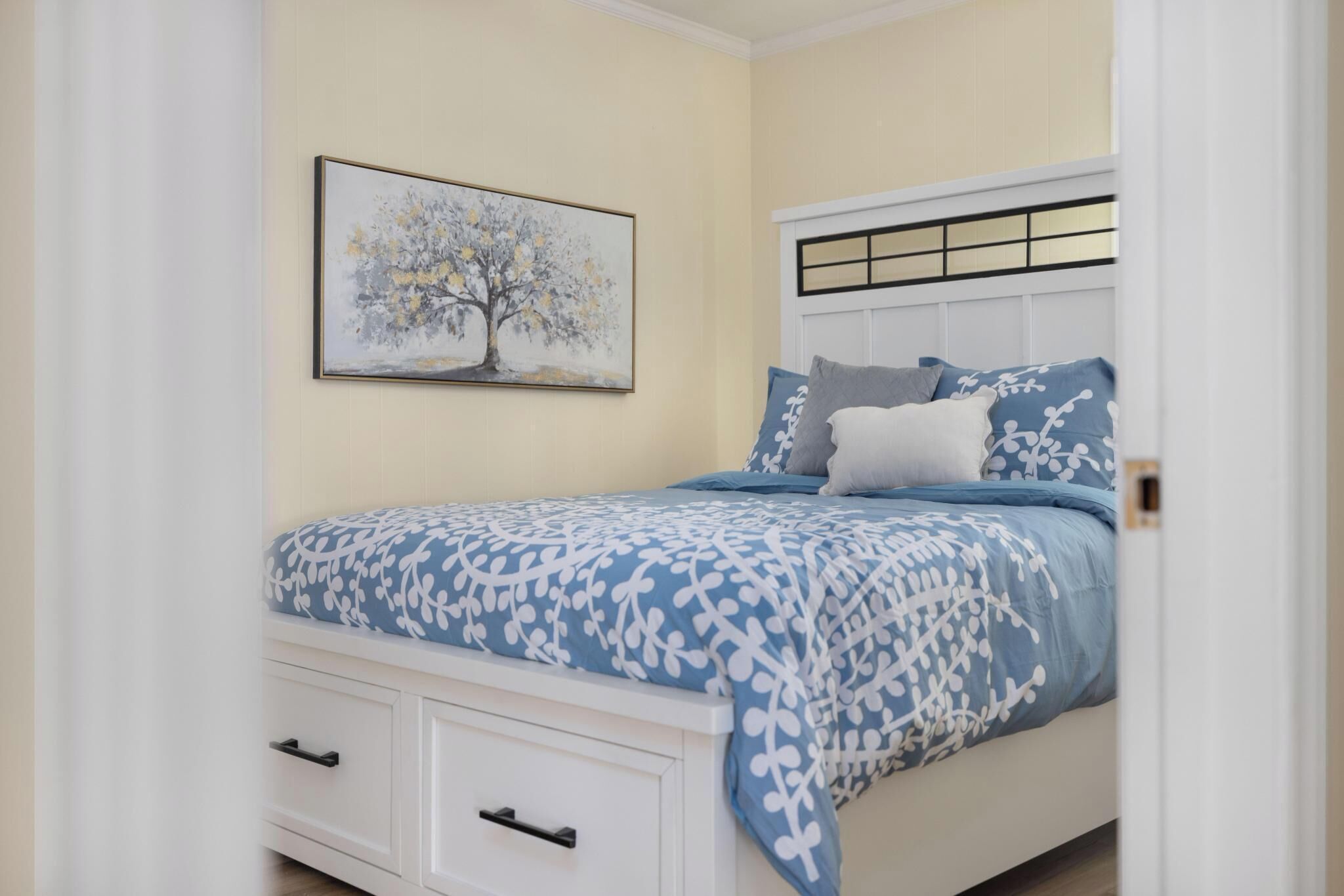 Cozy bedroom with storage bed and serene blue coastal-style decor